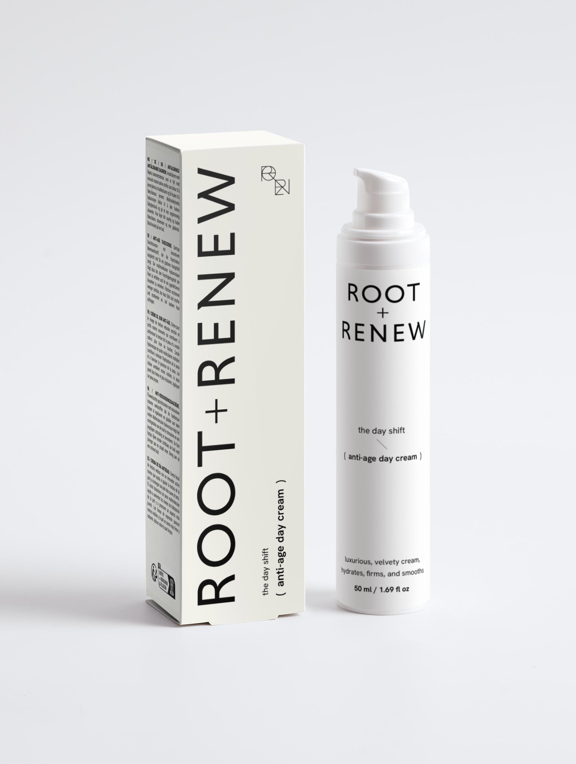 Front view of Root + Renew The Day Shift anti-age day cream bottle beside off-white product box with minimalist branding
