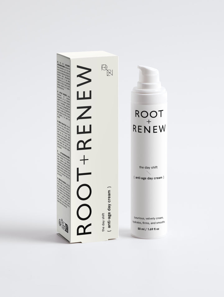 Front view of Root + Renew The Day Shift anti-age day cream bottle beside off-white product box with minimalist branding