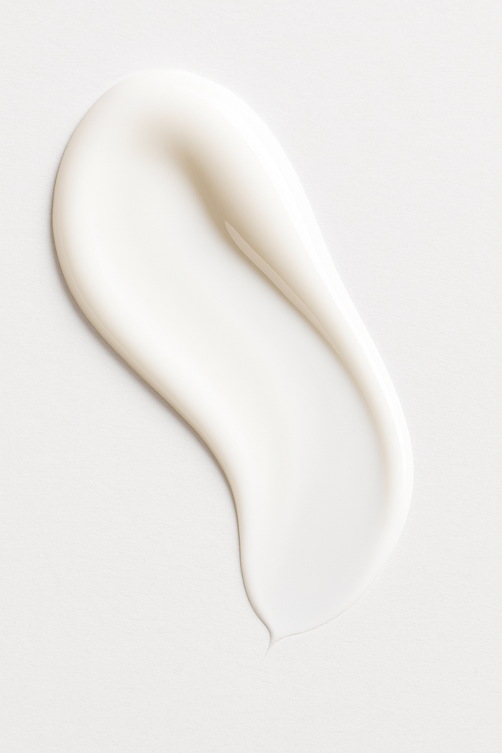 Close-up of Root + Renew hydrating cream swatch showing rich, silky white texture on a clean neutral background, highlighting moisturizing skincare formula.