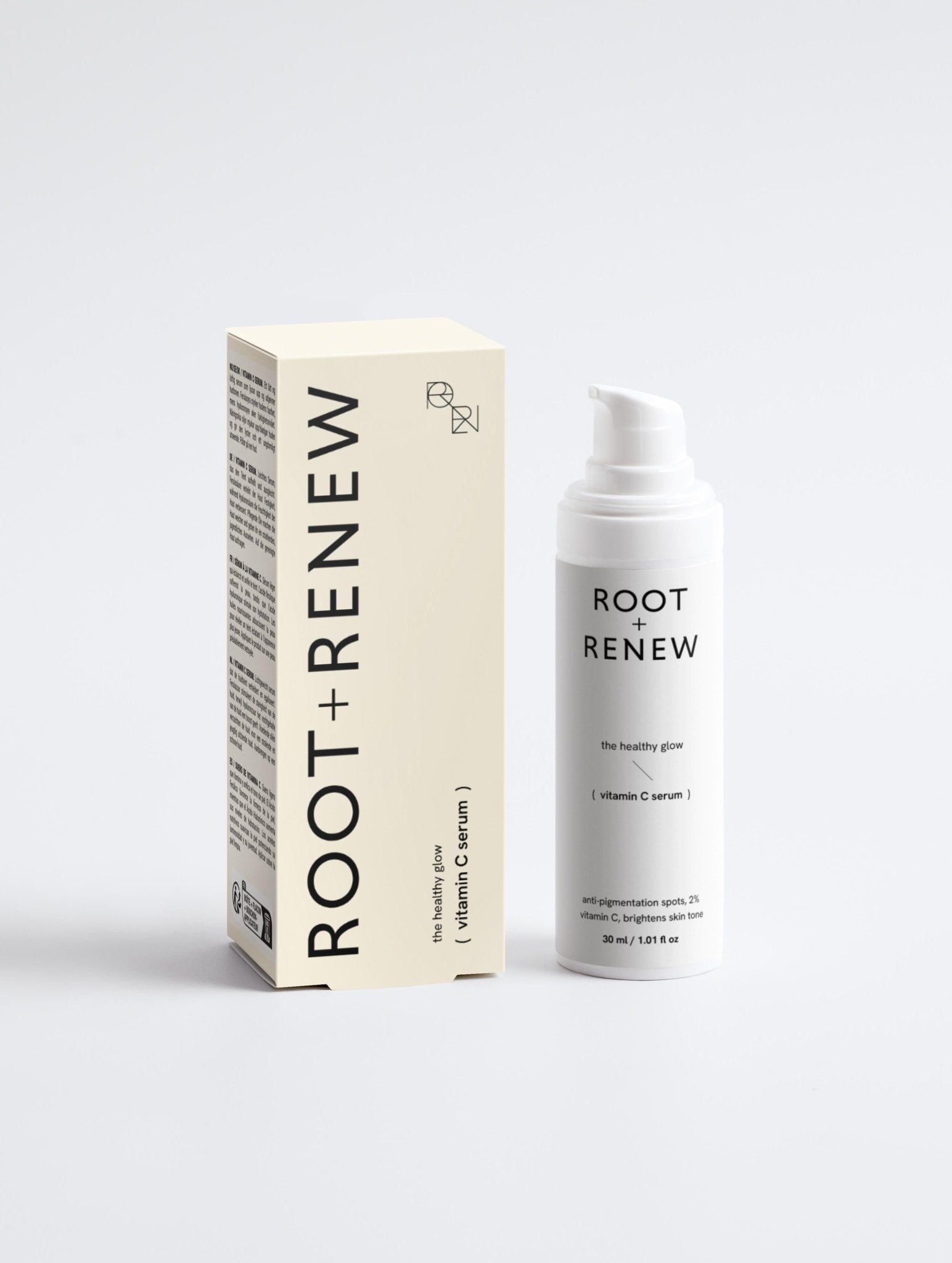 Root + Renew’s The Healthy Glow Vitamin C Serum bottle standing beside its outer box on a light background.