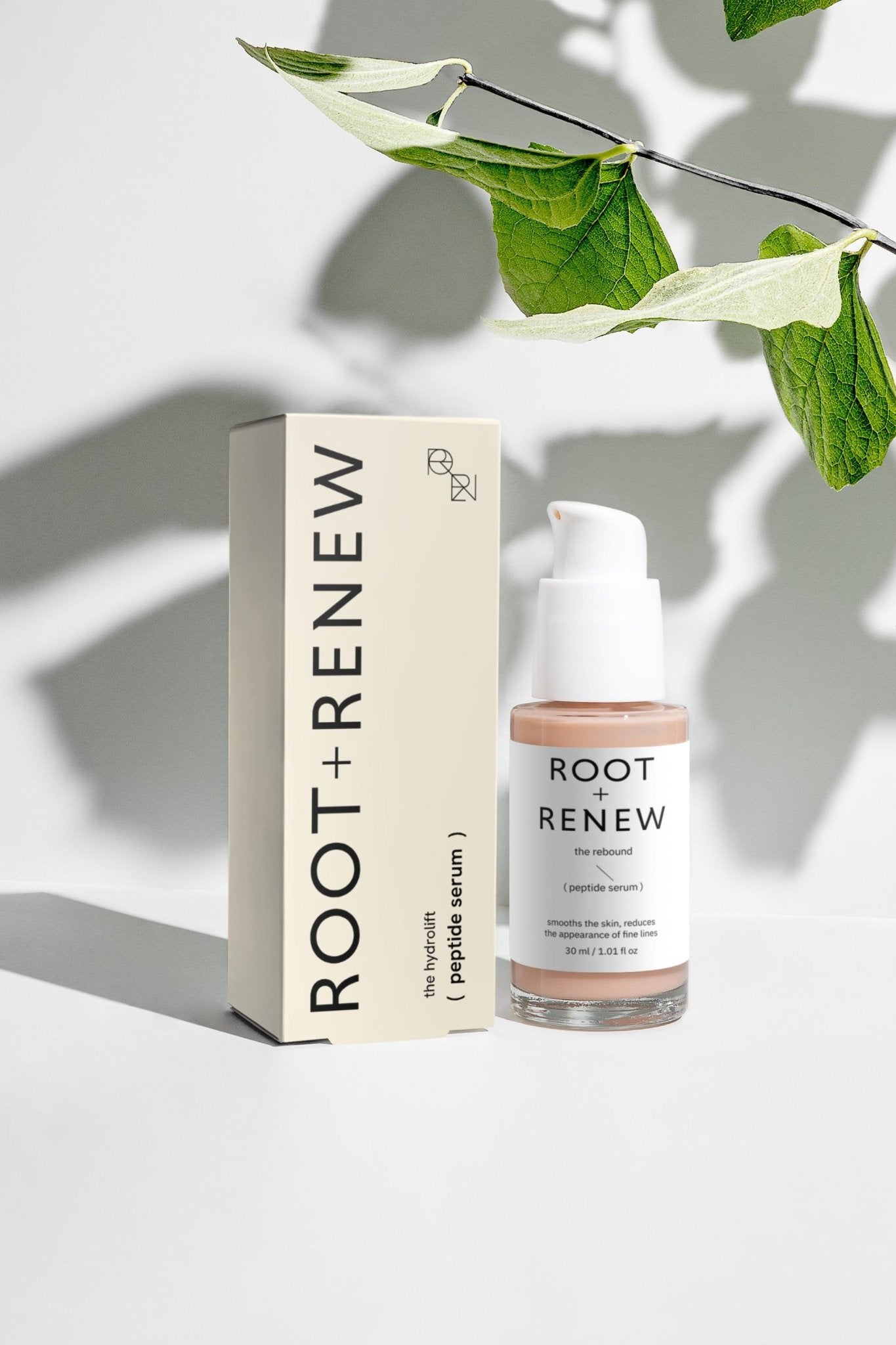 Lifestyle product shot of The Rebound Peptide Serum with greenery adding soft natural shadows.